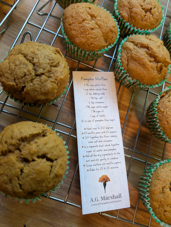 Pumpkin muffins on a cooling rack with a recipe card for A.G. Marshall.